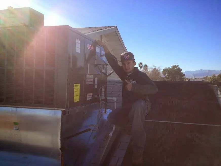 HVAC technician performing HVAC Inspection on a rooftop unit in Tullahoma